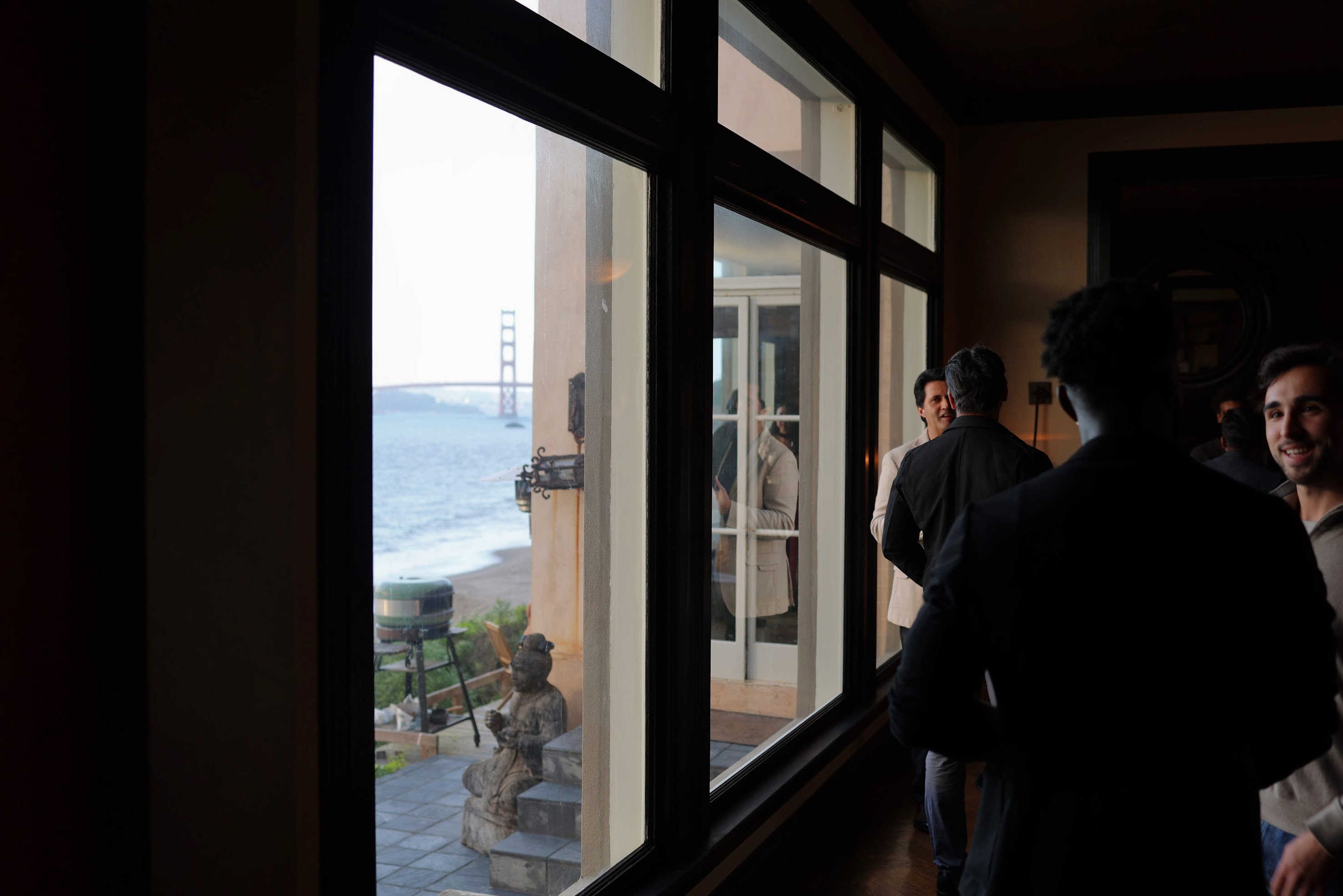 Conversations beside open doors overlooking the Golden Gate Bridge